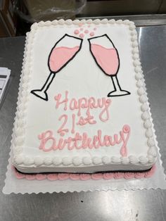 a birthday cake with two wine glasses on it and the words happy 21st birthday written in pink