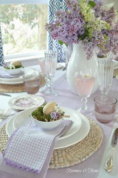 the table is set with dishes and place settings