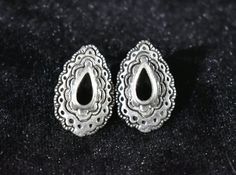 For sale is a pair of lovely vintage Sterling Silver Indian earrings in a teardrop-shape with a teardrop Onyx cabochon in the middle and stampwork along the edges. In very good vintage condition. Stamped to the back: 925. L:  7/8” W: ½”Store and Shipping PoliciesPaymentPayment is due within 48 hours of purchase using PayPal, credit card, debit card, or Etsy gift card. Louisiana residents are subject to sales tax (amount depending on Zip code). Shipping, Delivery and Local Pickup:At the moment, w Vintage Pierced Teardrop Earrings As Gift, Vintage Teardrop Pierced Earrings As Gift, Vintage Pierced Teardrop Earrings For Gifts, Vintage Teardrop Earrings Gift, Vintage Teardrop Earrings For Gift, Handmade Ornate Teardrop Earrings, Vintage Teardrop Clip-on Earrings As Gift, Vintage Teardrop Clip-on Earrings For Gift, Bohemian Nickel Free Teardrop Clip-on Earrings