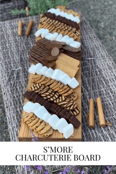 some cookies and marshmallows sitting on a table with the words, s'more charlotte board