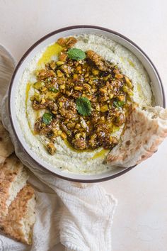 a bowl filled with hummus and some bread