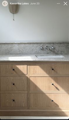 a bathroom vanity with two sinks under a mirror