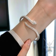 ✨💍 -- Sterling Silver Snake Bracelet - 💍✨ What's Included:  1x Sterling Silver Snake Bracelet 🚚 Free Delivery  ✅ Handmade and Handcrafted 💸 30 Day money back guarantee  ⭐️Specifications: Material - Silver Colour - Silver Introducing the Sterling Silver Snake Bracelet from CrystalGemJewellers! 💫💍 This gorgeous bracelet has a luxury feel, and is made out of genuine high-quality Silver, exuding elegance. 💫 Here at CrystalGemJewellers we specialise in handcrafting jewellery items made from ma Luxury Sterling Silver Snake-shaped Jewelry, Luxury Silver Snake Shaped Jewelry, Luxury Snake Bracelet For Formal Occasions, Luxury Sterling Silver Snake Jewelry, Silver Snake-shaped Bracelets For Gifts, Silver Snake-shaped Bracelet As Gift, Silver Snake-shaped Bracelet For Gift, Silver Snake Shape Bracelet As Gift, Snake Skin Bracelet