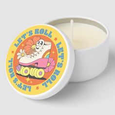 a candle that is inside of a white container with the words let's roll the dice on it