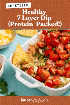 healthy 7 layer dip protein - packed with tomatoes and tortilla chips for dipping