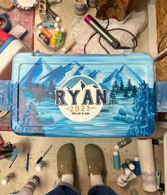 a person standing in front of a blue tray with the name ryan 2013 on it