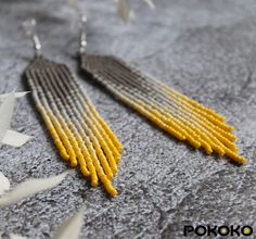 "These gray yellow earrings pair amazingly with any outfit, dressy or casual. They will emphasize your individuality and compliment your personality on various occasions. Perfect for looking pulled together and on trend. They are made of high-quality Czech colored beads with sterling silver hooks and silicone plugs. Colors: gray, yellow. Length: 4.1 inches (10.5 cm) Width: 0.78 inches (2 cm) Materials:     Czech \"Preciosa\" beads     Durable synthetic thread     Sterling silver ear hooks     Silicone plugs If you are on the hunt for a gift that will show your significant other some love, these picks are a great solution to surprise and delight. I hope you can find everything here that you were looking for. If you have any questions related to earrings design, please feel free to contact m Fringe Beaded Earrings, Red Bead Earrings, Turquoise Bead Earrings, Beige Earrings, Beaded Art, Native American Beaded Earrings, Seed Bead Tutorial, Luxury Earrings, Beading Ideas