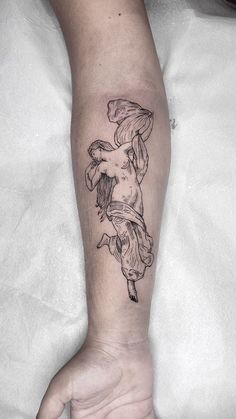 a woman's arm with a tattoo on it that has an image of a cherub