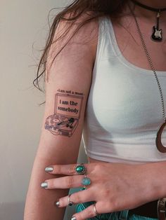 a woman with a book tattoo on her arm