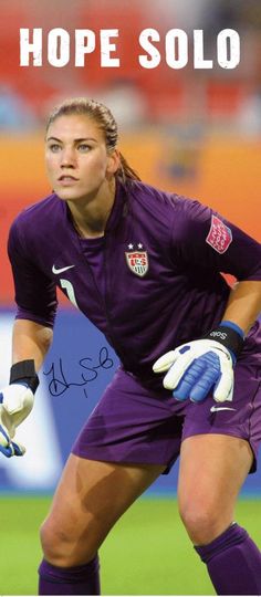 a female soccer player in purple uniform holding a ball and wearing white gloves with the words hope solo on it