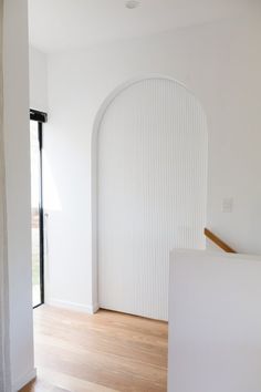 an empty room with white walls and wood flooring is pictured in this image from the doorway