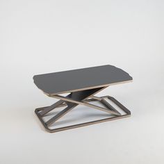 a black and gold coffee table sitting on top of a white floor