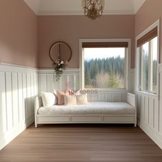 a white day bed sitting next to a window in a room with wood flooring