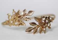 This gorgeous arm band is decorated with a nice variety of leaves, flowers and pearls. Size is around 10inch/25cm. This size could be slightly adjusted to become bigger or smaller. Please measure you arm before to make sure this is a good fit. Otherwise please contact me. * Comes wrapped in a pretty gift bag. * Choose between 14k gold, rose gold or silver plated brass. For updates, new products, one-of-a-kind's, special offers and more- like us on Facebook: https://www.facebook.com/avigailadamje Brass Cuff Bracelet With Intricate Design For Wedding, Gold Flower Pearl Bracelet For Wedding, Arm Cuff Jewelry Gold, Arm Cuff Jewelry Art Deco, Gold Upper Arm Cuff, Gold Leaf Arm Cuff, Bridal Jewerly, Bridesmaid Bracelets, Gold Leaf Crown