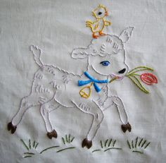 a white embroidered sheet with an image of a dog holding a flower in it's mouth