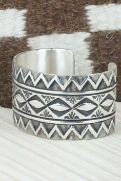 This sterling silver bracelet was made by Navajo silversmith Elvira Bill. The bracelet is signed Elvira Bill and stamped sterling.Size: 5 1/4" (will fit up to a 6 3/8" wrist)Gap: 1 1/8"Width: 1 1/2"Free shipping on all orders! We ship with USPS and always include tracking. All orders ship within a day of payment.Returns are accepted up to 30 days after you receive your order. Just send us a message. Our shop offers cash back or store credit. The item must be returned in new condition. Southwestern Stamped 925 Cuff Bangle Bracelet, Southwestern Style 925 Silver Bracelets, Sterling Silver Southwestern Bracelet, Southwestern Sterling Silver Bracelet, American Jewelry, Sterling Silver Bracelet, Native American Jewelry, Free Jewelry, Sterling Silver Bracelets