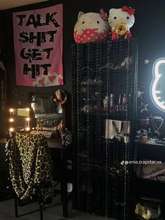 a room with hello kitty decorations on the wall and candles in front of her desk