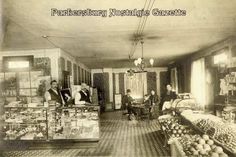 an old black and white photo of people in a store