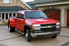 a red truck parked in front of a house