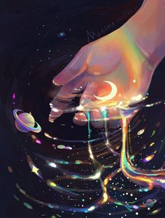 a person's hand reaching for something in the air with colorful lights on it