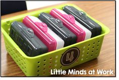 four little minds at work pencils in a green container on a wooden table with the title, little minds at work