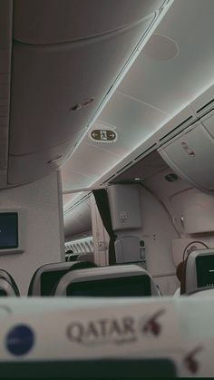 the inside of an airplane with rows of seats