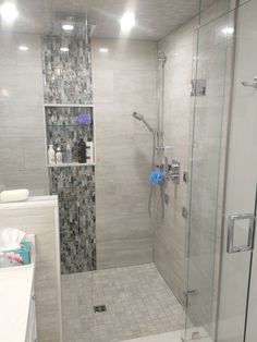 a walk in shower sitting next to a sink