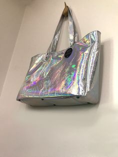 Large Holographic Leather Tote Handmade in Australia - Smooth soft holo leather - shown with gunmetal hardware and Lining 4 inside: Magnetic closure or choose zipper close 3 slip pockets Swivel clasp for keys Outside: - Strong Flat Shoulder Straps, stitched and riveted. Length 69cm. - Metal feet on bottom Size: Length: 40cm (15.7 inch) Depth: 10cm (3.9 inch) Height: 28cm (11 inch) * An everyday bag, fitting everything you need. * Fully lined in your choice of quality lining fabric (see options) Metallic Tote Shoulder Bag For Everyday, Everyday Metallic Tote Shoulder Bag, Metallic Rectangular Shoulder Bag For Everyday, Iridescent Rectangular Travel Bag, Trendy Iridescent Bag For Everyday Use, Iridescent Trendy Bag For Everyday Use, Trendy Iridescent Bags For Everyday Use, Iridescent Rectangular Shopping Bag, Rainbow Bag