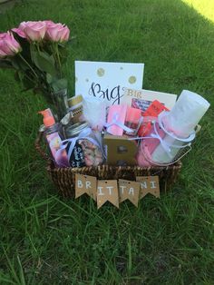 a basket filled with lots of items sitting on top of a lush green field next to a sign