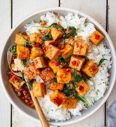 a white bowl filled with rice and tofu