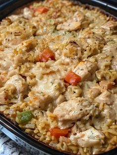 a casserole dish with chicken and rice in it on top of a table