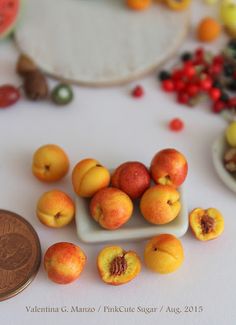 there are many small pieces of fruit on the table next to a penny and some beads