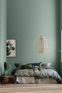 a bedroom with green walls and wooden floors is featured in the instagram post on instagram