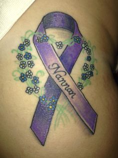 a woman's stomach with a purple ribbon and flowers on it