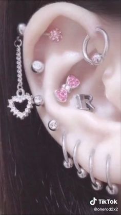 a close up of a person with ear piercings on their ears and behind the ear