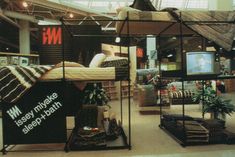 an indoor store with multiple beds and furniture in it's display area for sale