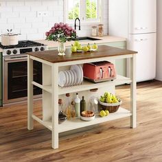 a kitchen island with plates and bowls on it in front of a stove top oven