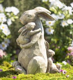 a statue of a bunny holding a baby rabbit