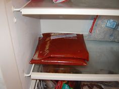 an open refrigerator with some food in the freezer and other items on the shelves