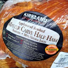 a close up of a large piece of bread in plastic wrap on the shelf at a store