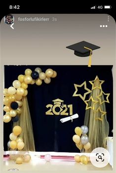 balloons and streamers in front of a graduation backdrop