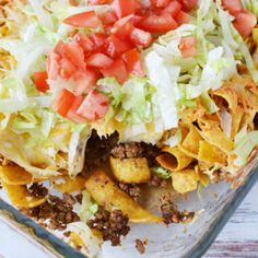 a glass casserole dish filled with taco salad