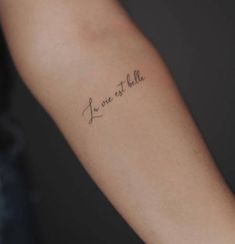 a person with a tattoo on their arm that says i'm one to fall