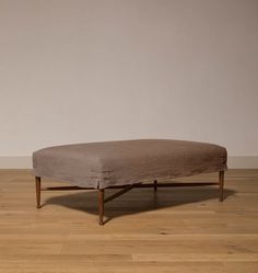 a large ottoman sitting on top of a wooden floor