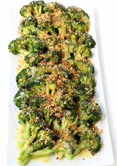 broccoli florets on a white plate topped with parmesan sprinkles