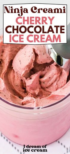 a bowl filled with ice cream next to a spoon and sign that says cherry chocolate ice cream