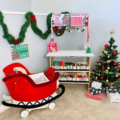 a room decorated for christmas with toys and presents on the floor, including a sleigh