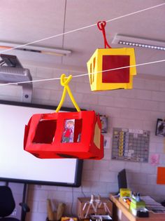 some red and yellow boxes hanging from a line