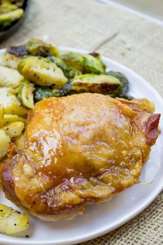 a white plate topped with chicken, potatoes and brussel sprouts