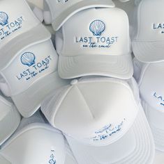 white caps with blue writing on them sitting next to each other in front of one another